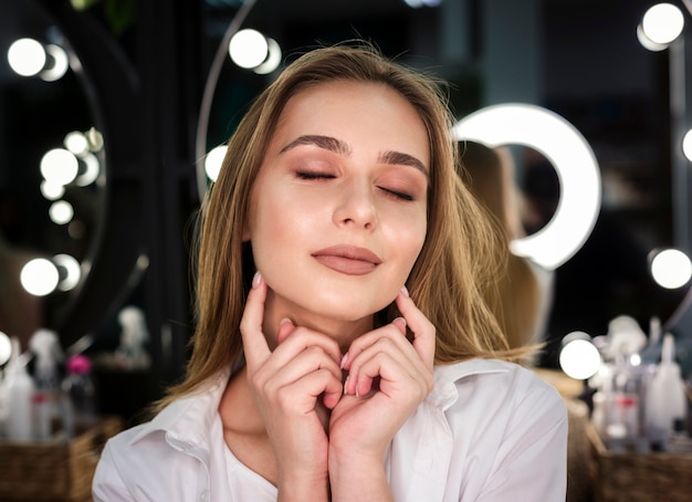 Woman touching face with eyes closed