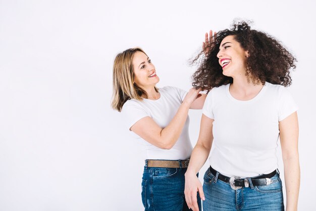 Woman touching hair of daughter