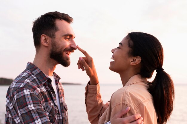 Woman touching her boyfriend's nose in a cute way