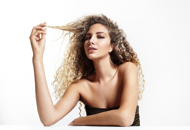 Free photo woman touching her curly hair