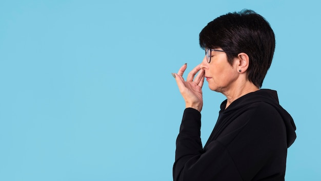 Woman touching her nose with copy space