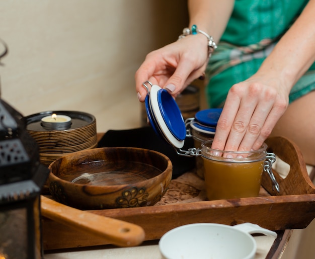 Free photo woman touching mead in a jar