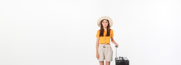 Free photo woman tourist full length happy young woman standing with suitcase with exciting gesturing isolated