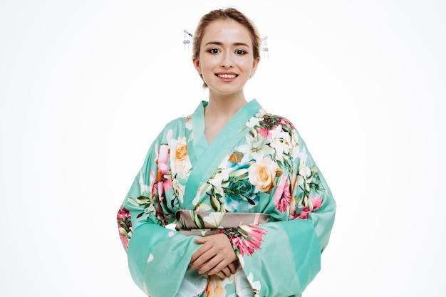 Woman in traditional japanese kimono smiling confident happy and positive on white