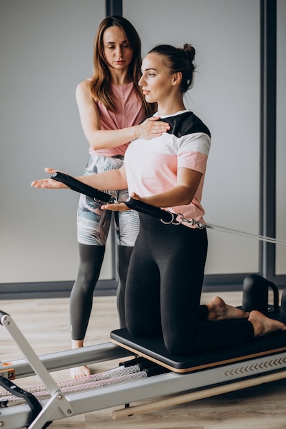 Free photo woman training pilates on the reformer