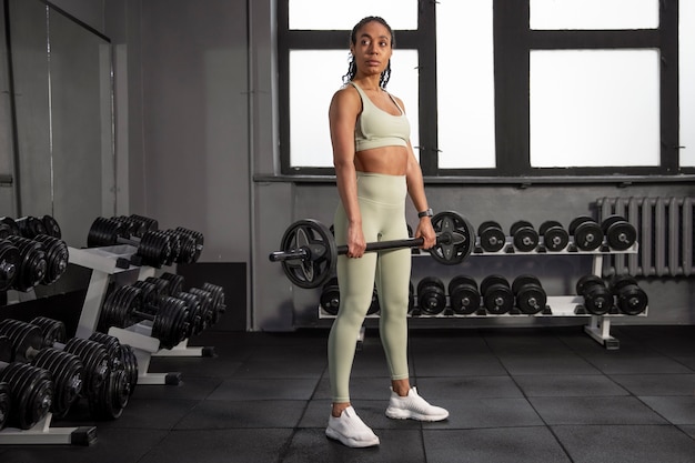 Woman training for weightlifting in gym