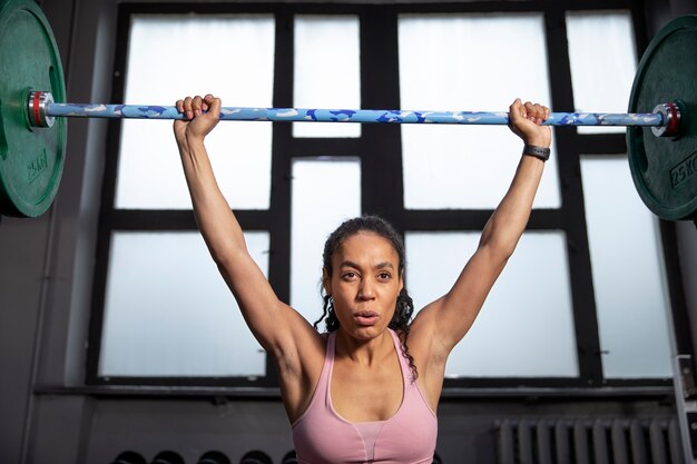 Woman training for weightlifting in gym