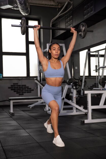 Woman training for weightlifting in gym