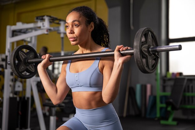 Woman training for weightlifting in gym