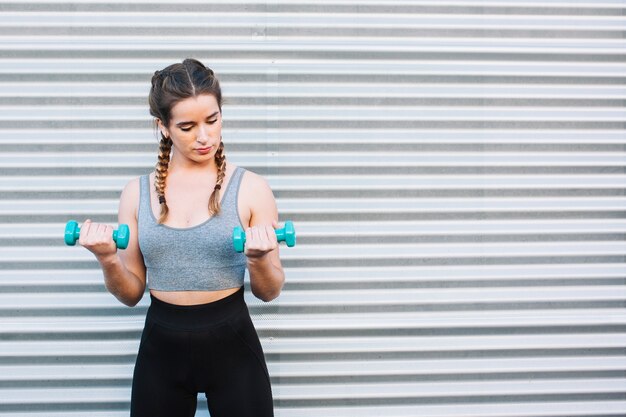 Woman training with dumbbells