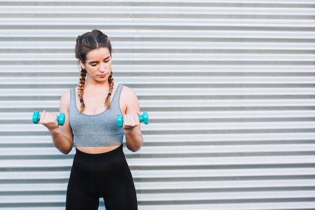 Woman training with dumbbells