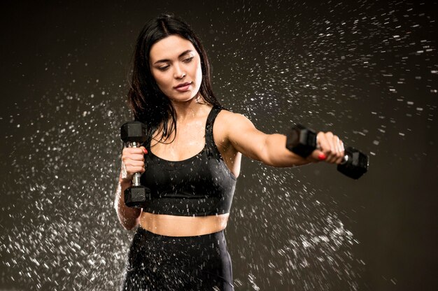 Woman training with hand weights