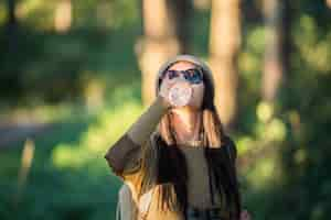 Free photo woman traveler going alone in the forest