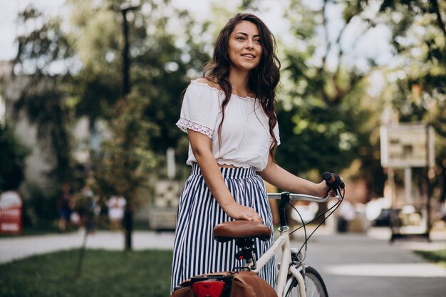 Woman travelling on bicycle in town