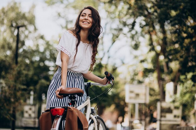 Woman travelling on bicycle in town