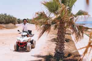 Free photo woman travelling on quad by th ocean