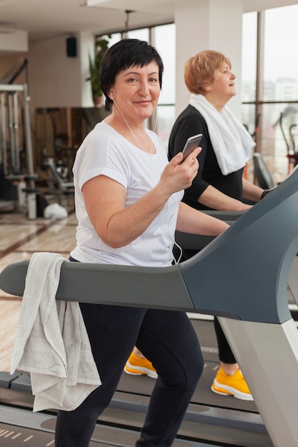 Woman on treadmill with mobile