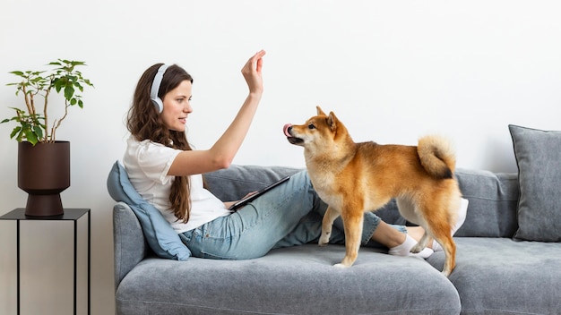 Free photo woman trying to concentrate next to her dog