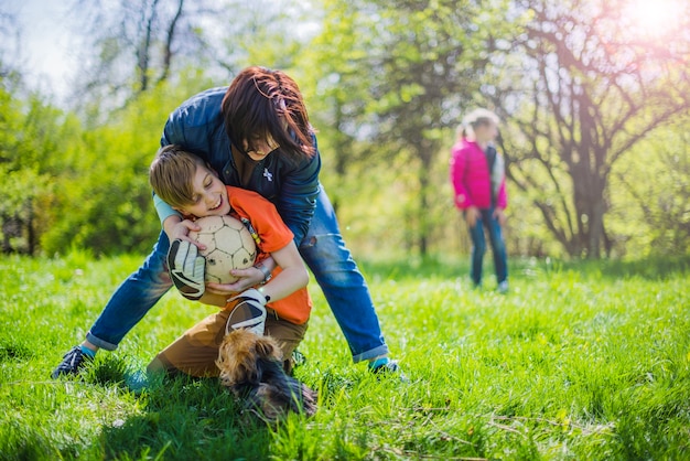 Woman trying to take the ball off her son