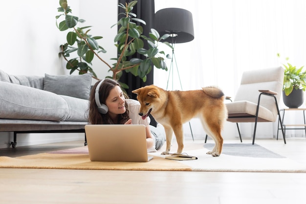 Woman trying to work next to her dog