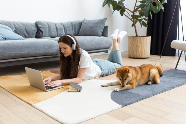 犬の隣で仕事をしようとする女性