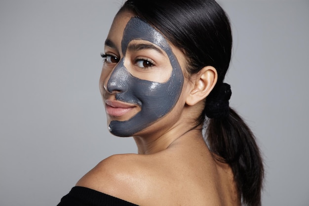 Woman turned back to camera with facial mask on