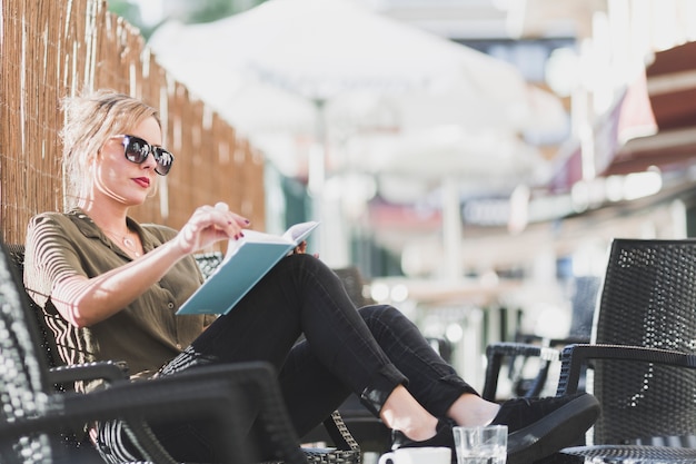 woman turning pages of book