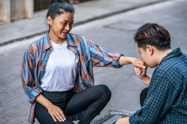 2人の恋人の女性が座って、お互いの手にキスをしました。