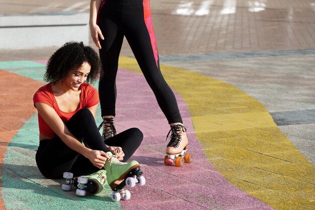 Woman tying on her roller skates outdoors