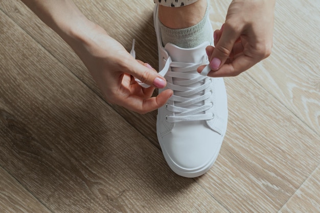 Free photo woman tying shoelaces