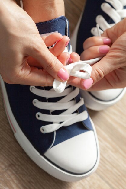 Woman tying shoelaces