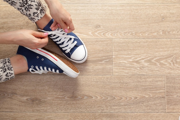 Woman tying shoelaces, topánky na cvičenie