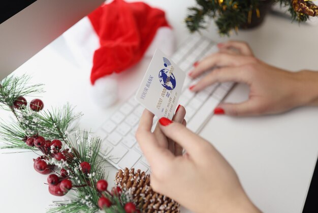 Woman typing credit card number on keyboard want to pay online in cashless way