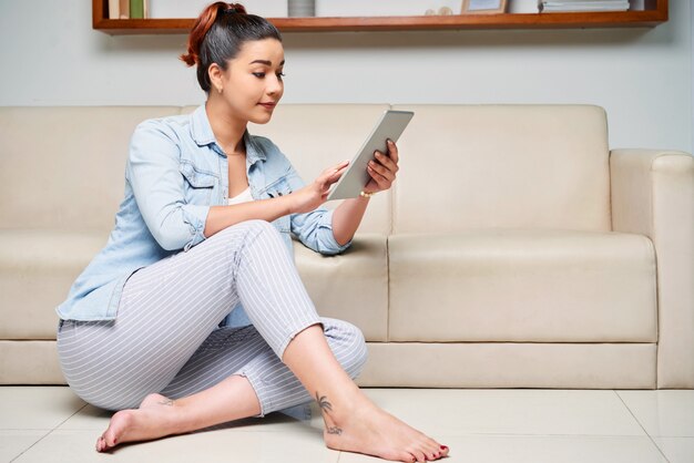 Woman typing on tablet