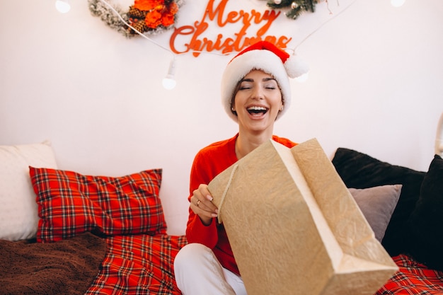 Free photo woman unpacking gifts on christmas