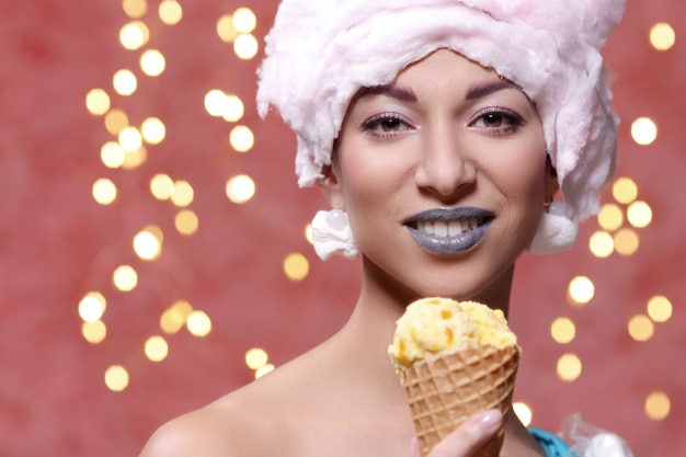 Free photo woman in unusual dress made of marshmallow and wig of cotton candy