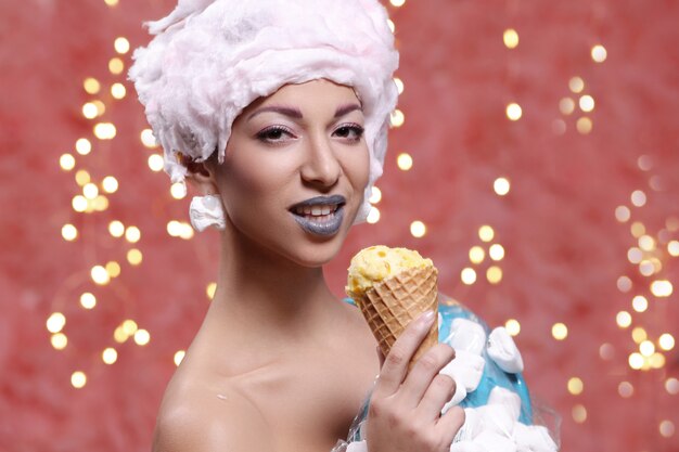 Woman in unusual dress made of marshmallow and wig of cotton candy