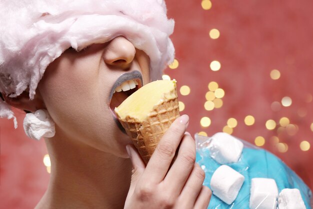 Woman in unusual dress made of marshmallow and wig of cotton candy