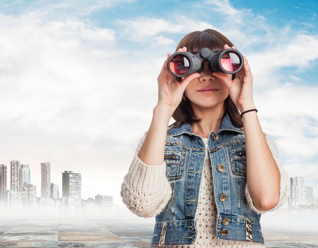 Woman using binoculars with city background