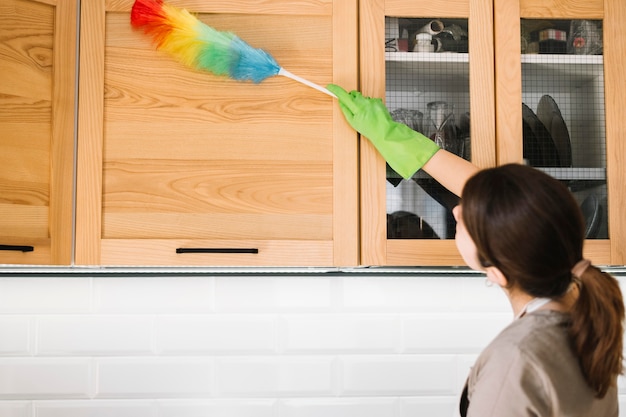 Woman using colorful fluffy duster