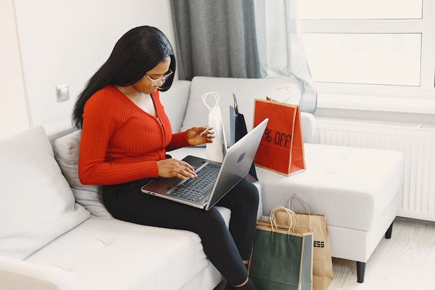 Woman using computer and credit card