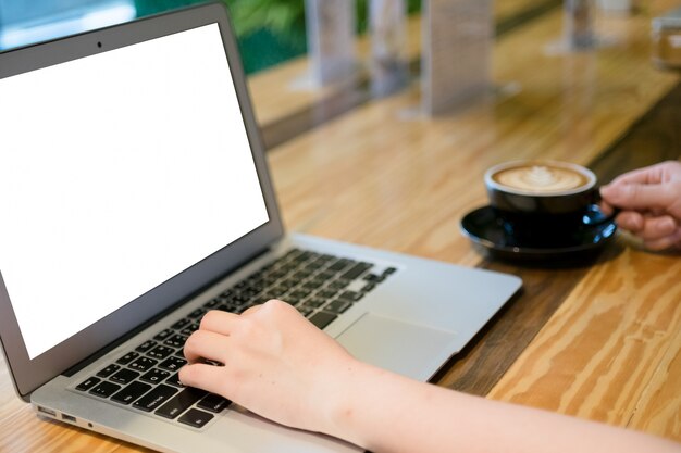 Woman using computer laptop in coffee shop