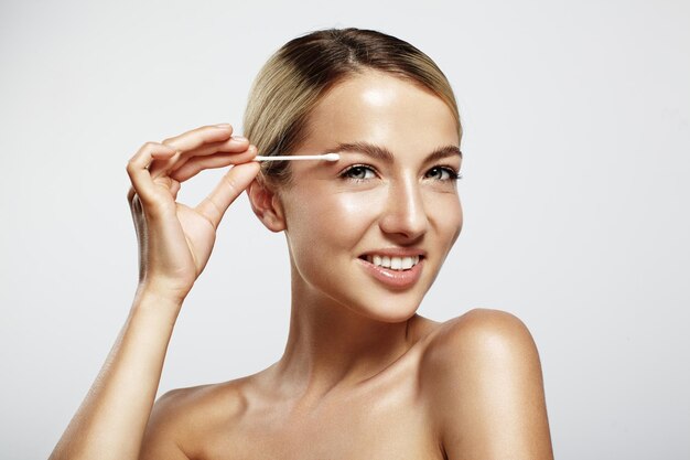 Woman using a cotton swab for a face