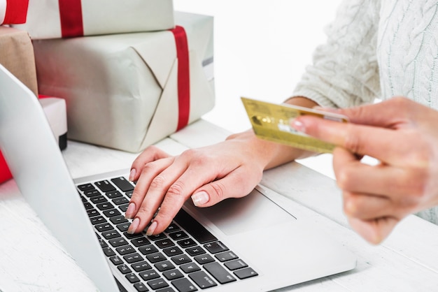 Woman using credit card at table