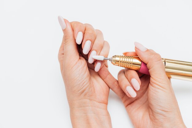 Woman using a digital nail file