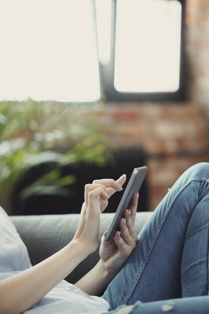 woman using digital tablet or smartphone