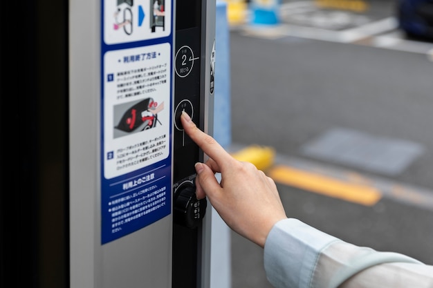 Woman using the electric car charging station