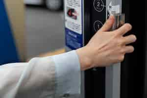 Free photo woman using the electric car charging station