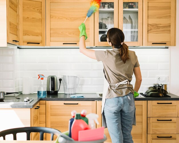 Woman using fluffy duster