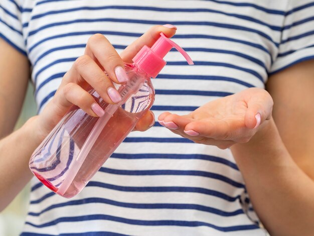 Woman using hand sanitizer